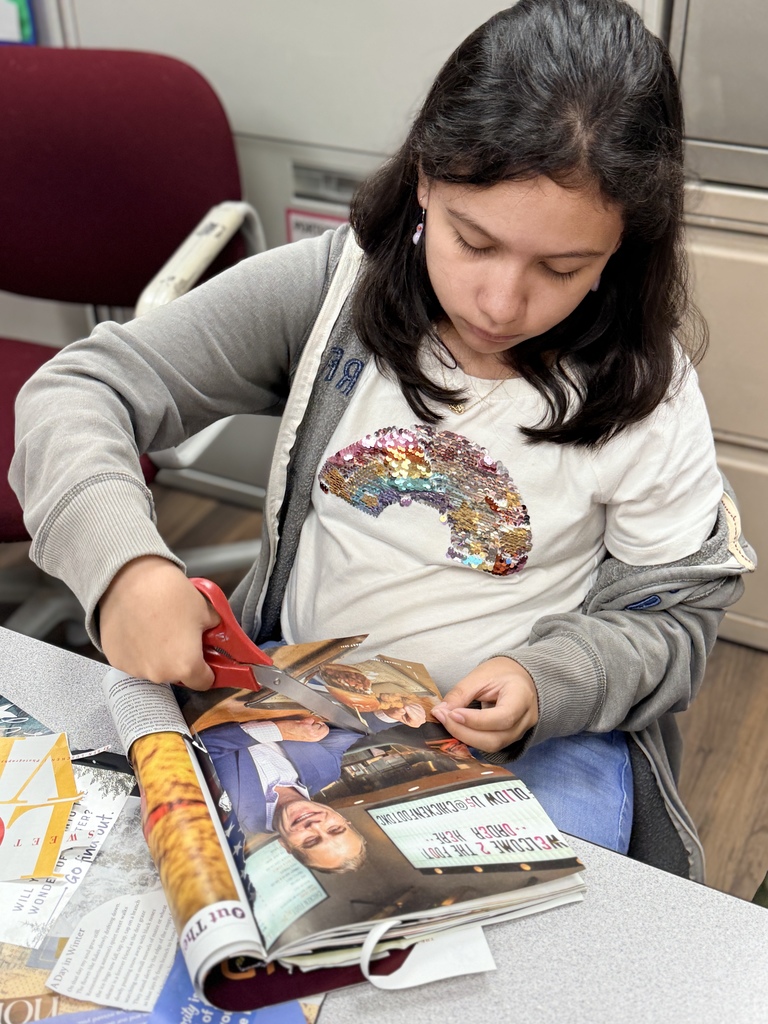 Student cutting out things for her art journal