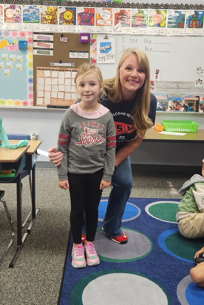 student and teacher dressed in college gear 