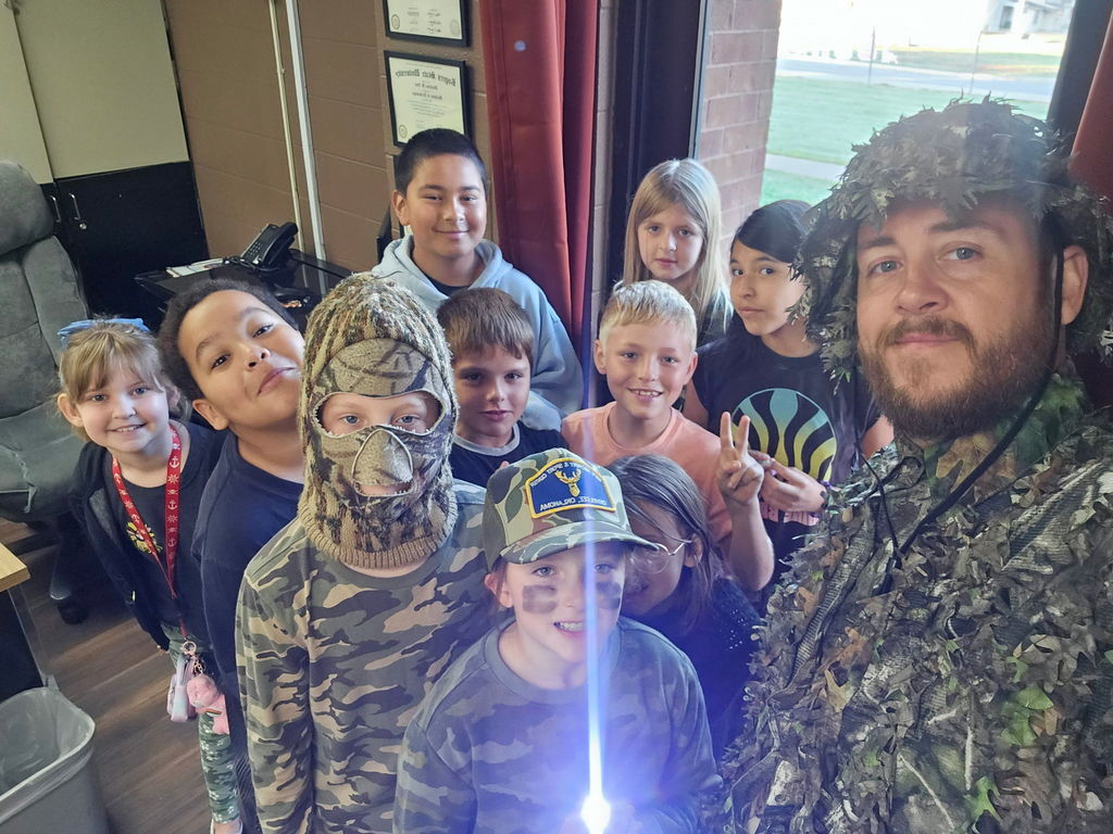 teacher with students wearing camo