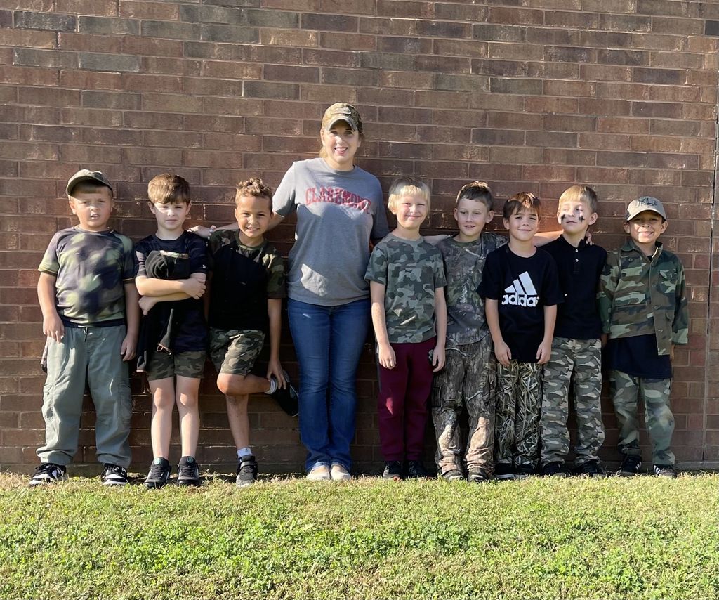 teacher with students wearing camo