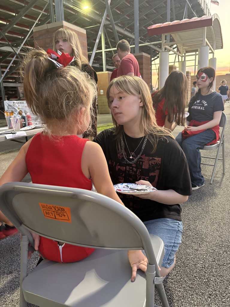 CHS art student painting faces at the football game