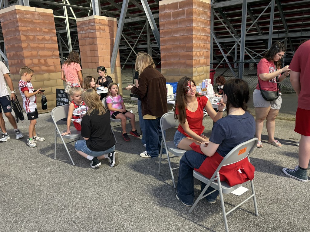 Art Painting faces at the football game.