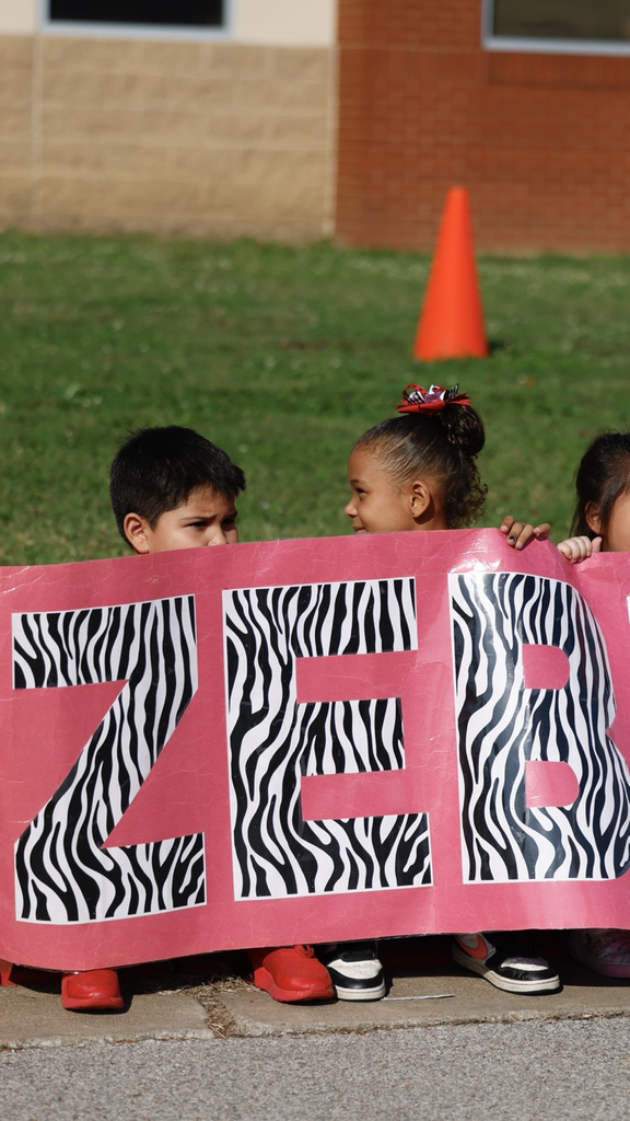two kids holding Zebs sign