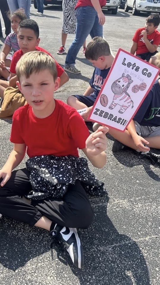 one kid holding zebra sign