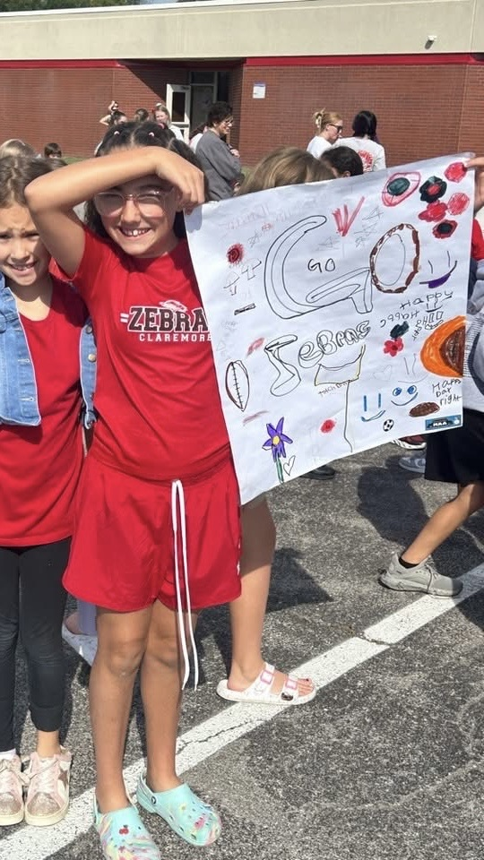 one kid holding zebra sign