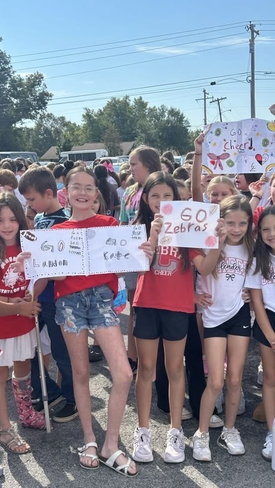 group of kids holding signs
