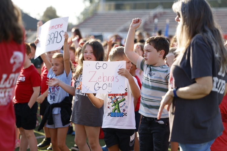 kids holding zebra signs