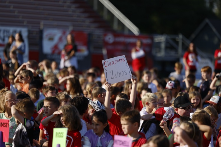 kids holding zebra sign