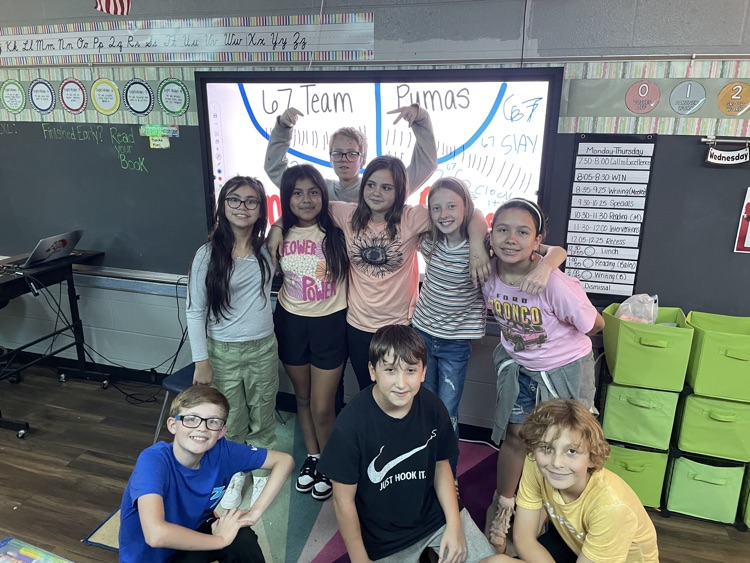 students celebrating their win in front of the smart board