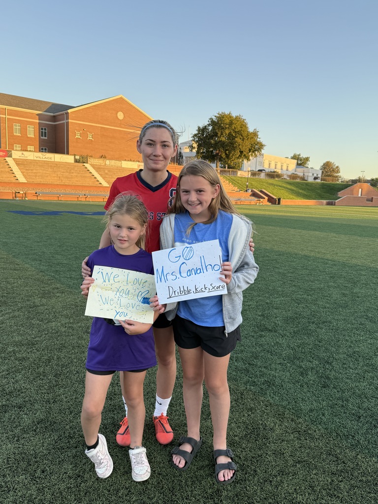 Mrs. C with two Claremont students holding signs