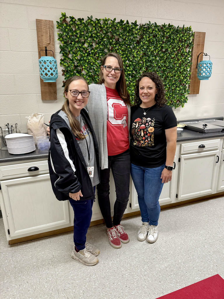 School nurse, 5th grade teacher, and PTO member standing in front of food provided by PTO