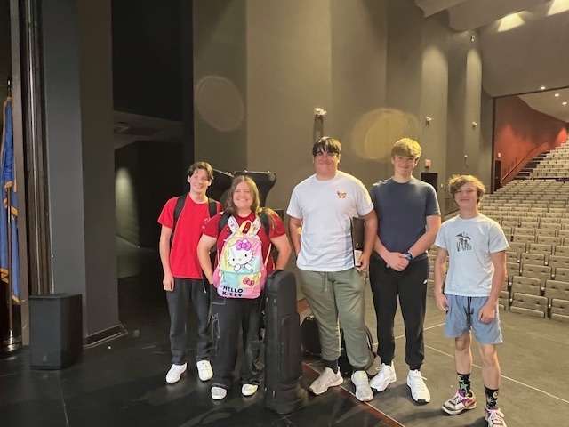 5 Claremore High School trombone players at owasso high school for a clinic