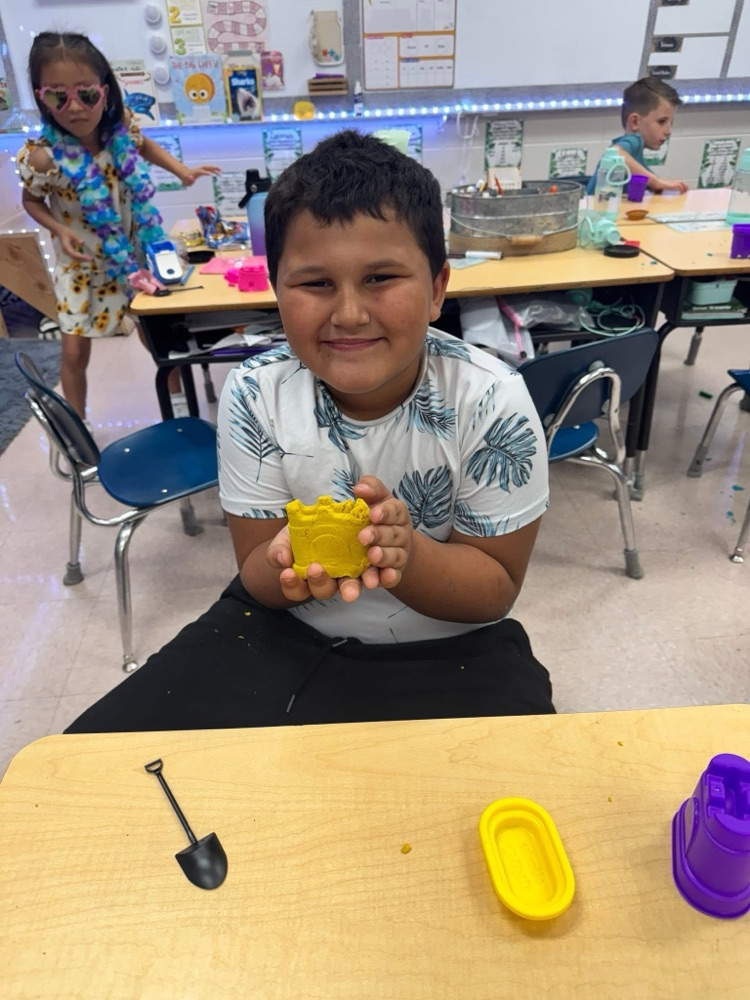 student playing with kinetic sand