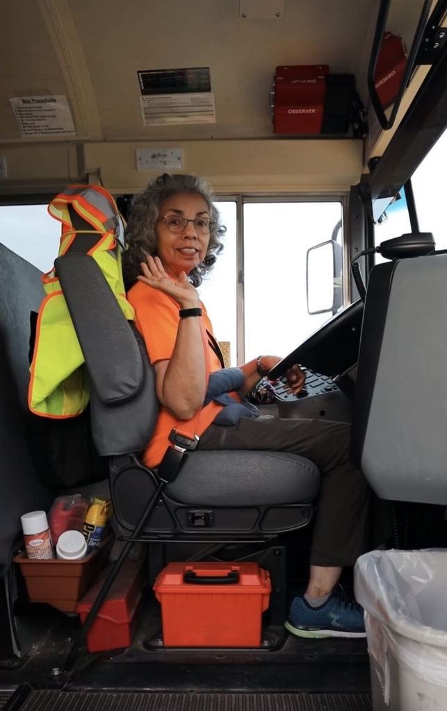 girl bus driver waving