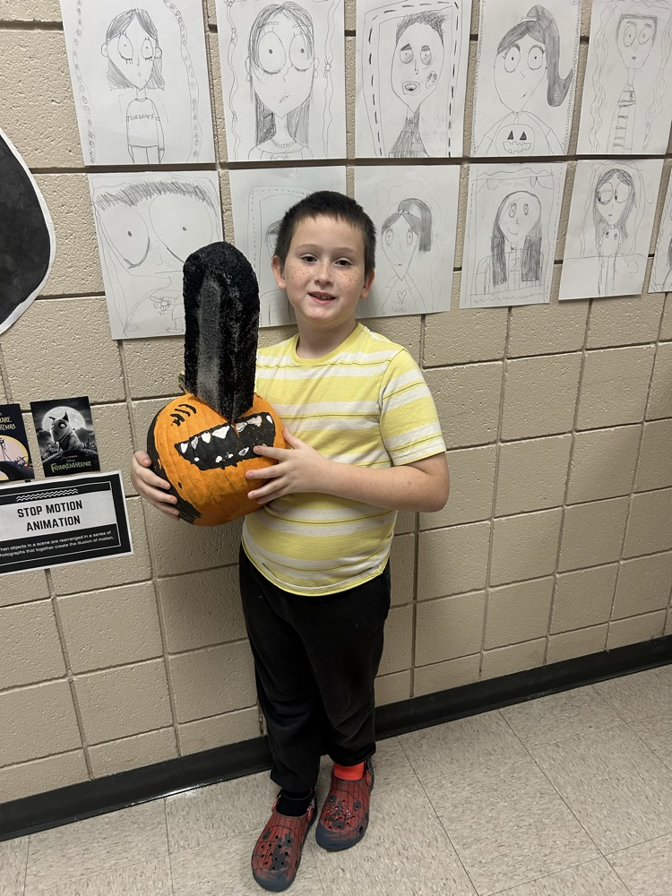 student with pumpkin