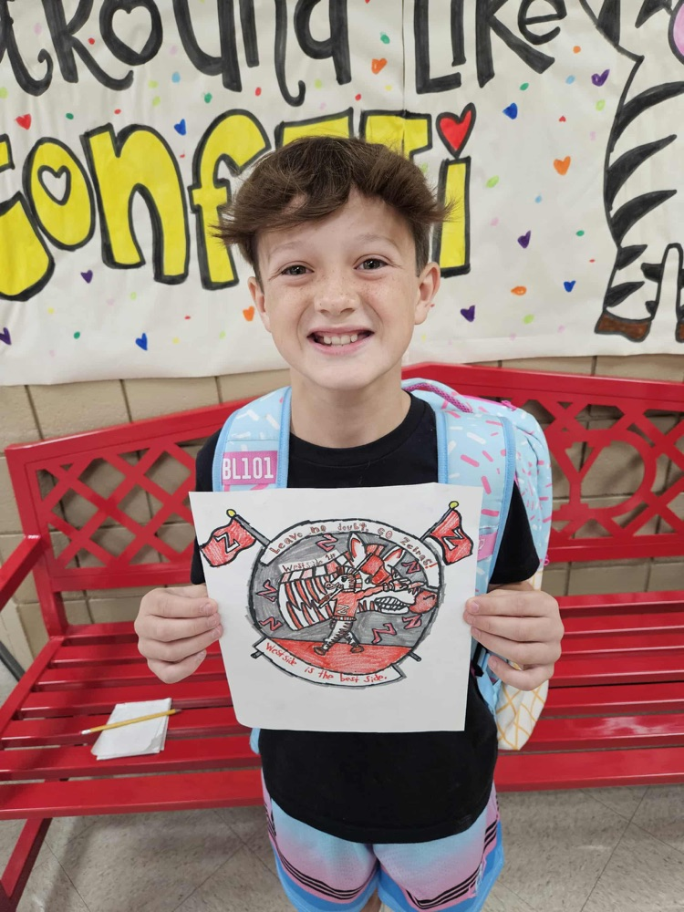 Student holding artwork with zebra on it.