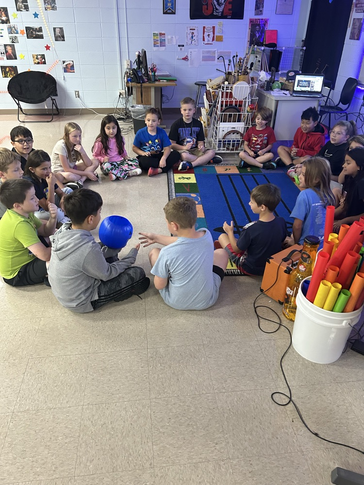 Music class at westside passing a ball and leaning about rhythm 