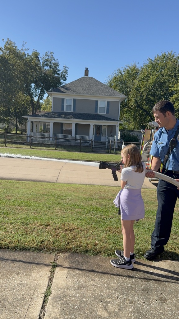 Student spraying water with firefighter