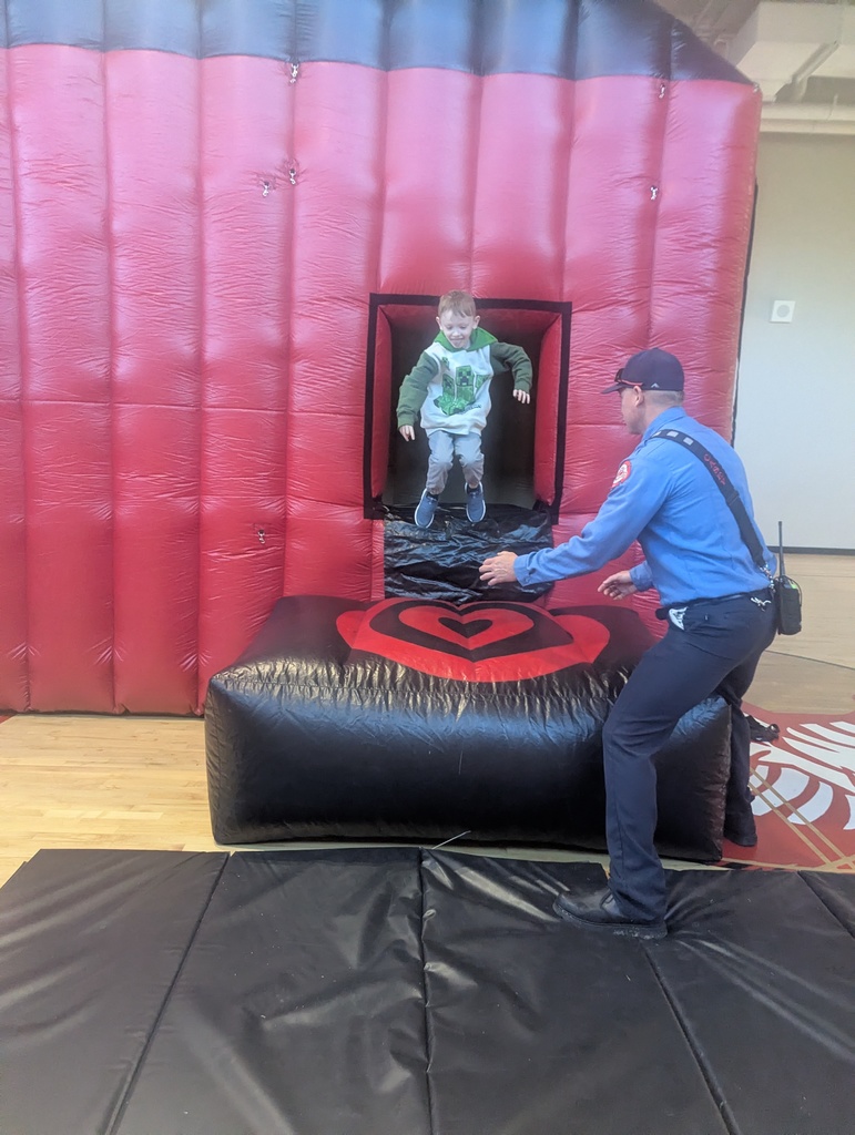 Student jumping out of bounce house