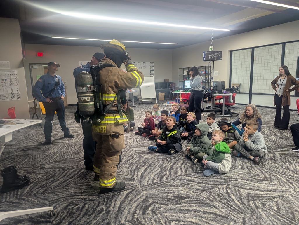 students learning from firefighter