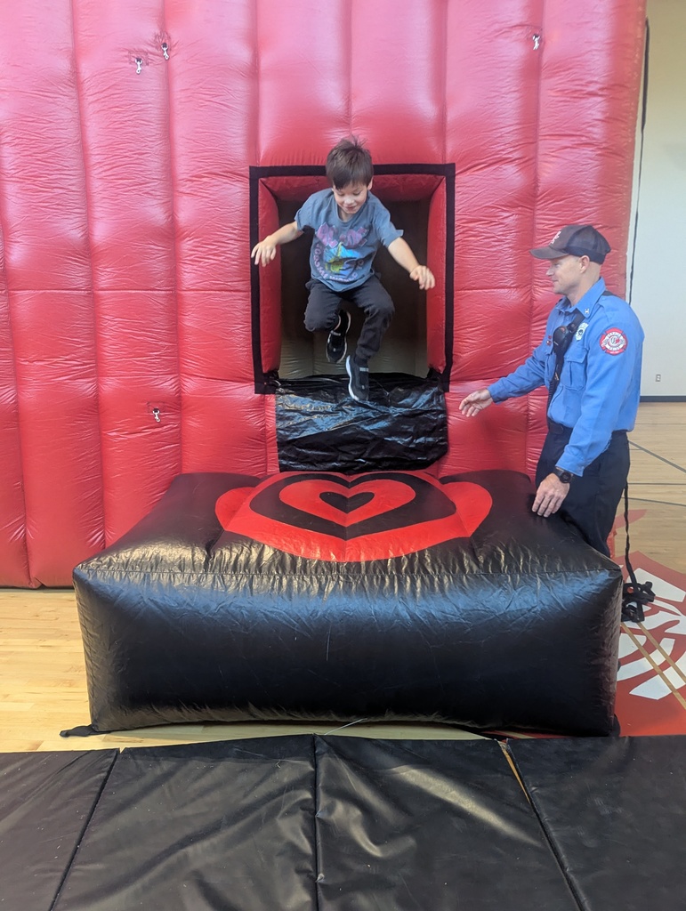 Student jumping out of bounce house