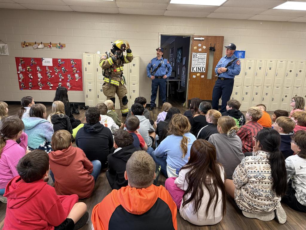 students learning from firefighter
