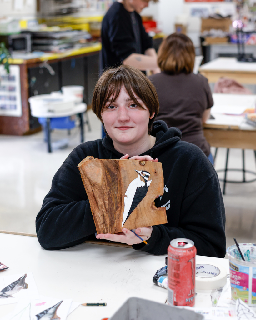 Art student showing their work in progress painting