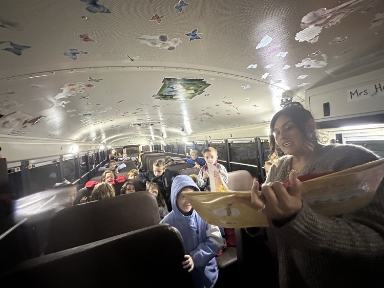 Miss Hartley reading to students