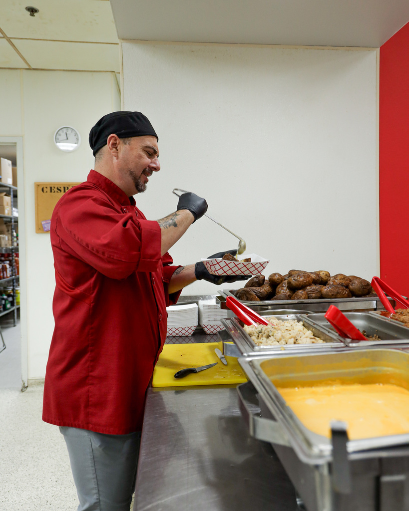 Chef Ryan serving baked potatoes