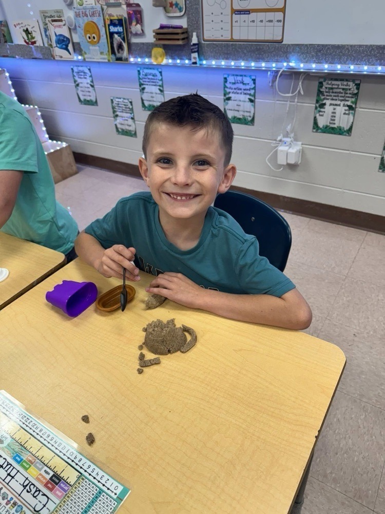 westside elementary students building a sandcastle