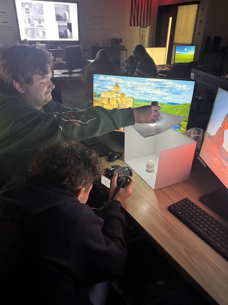 Check out Ms. Johnson’s photography class in action! 📸 Students are getting hands-on experience photographing eggs using flashlights to explore the differences between soft and hard lighting. Through this creative exercise, they’re learning how light affects depth, shadow, and value—key skills for mastering photographic techniques. It’s amazing to see them experiment and discover the power of lighting firsthand!