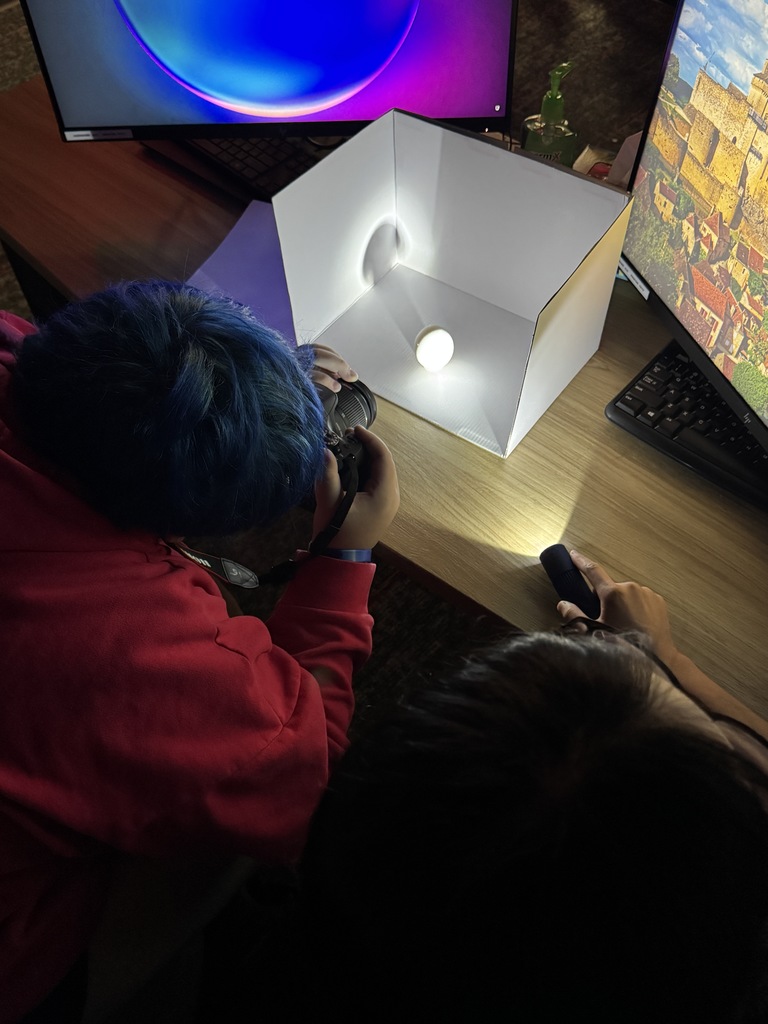 Check out Ms. Johnson’s photography class in action! 📸 Students are getting hands-on experience photographing eggs using flashlights to explore the differences between soft and hard lighting. Through this creative exercise, they’re learning how light affects depth, shadow, and value—key skills for mastering photographic techniques. It’s amazing to see them experiment and discover the power of lighting firsthand!