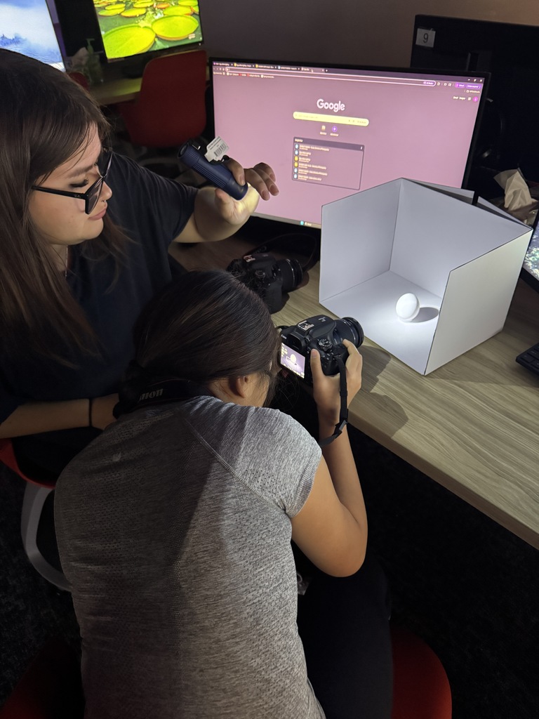 Check out Ms. Johnson’s photography class in action! 📸 Students are getting hands-on experience photographing eggs using flashlights to explore the differences between soft and hard lighting. Through this creative exercise, they’re learning how light affects depth, shadow, and value—key skills for mastering photographic techniques. It’s amazing to see them experiment and discover the power of lighting firsthand!