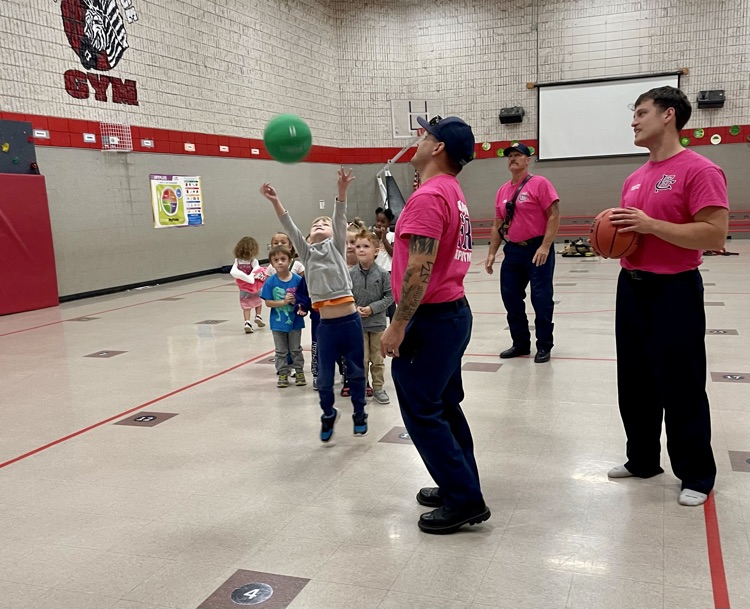 students shooting basketballs 