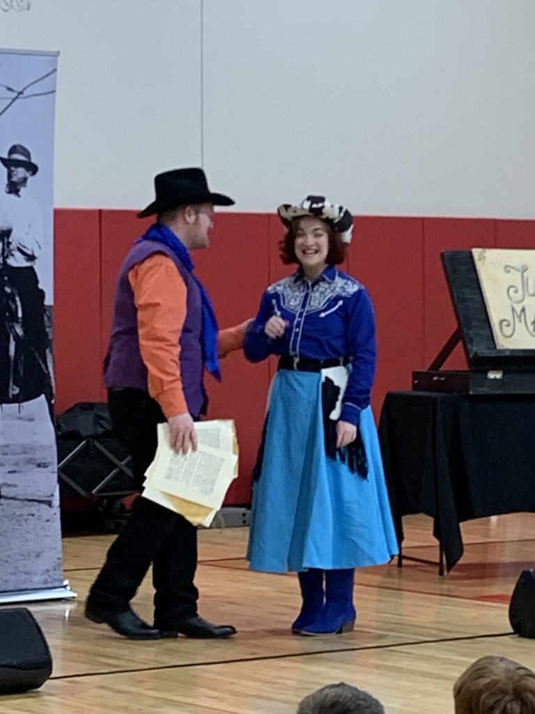 Man and woman talking and smiling as part of the play