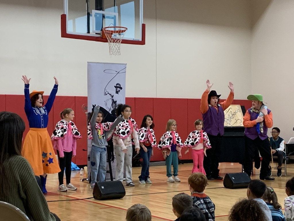 Hands are up and everyone is smiling and having a good time at the musical.