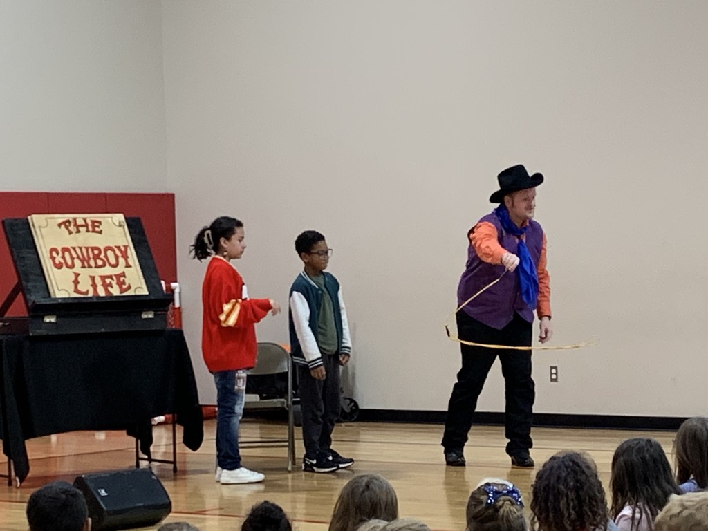 Man showing two students how to work a lasso in front of the class