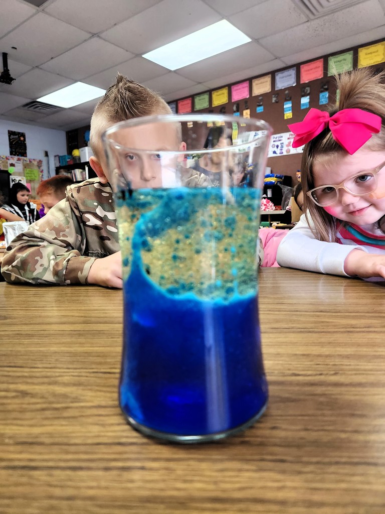 students looking at science project