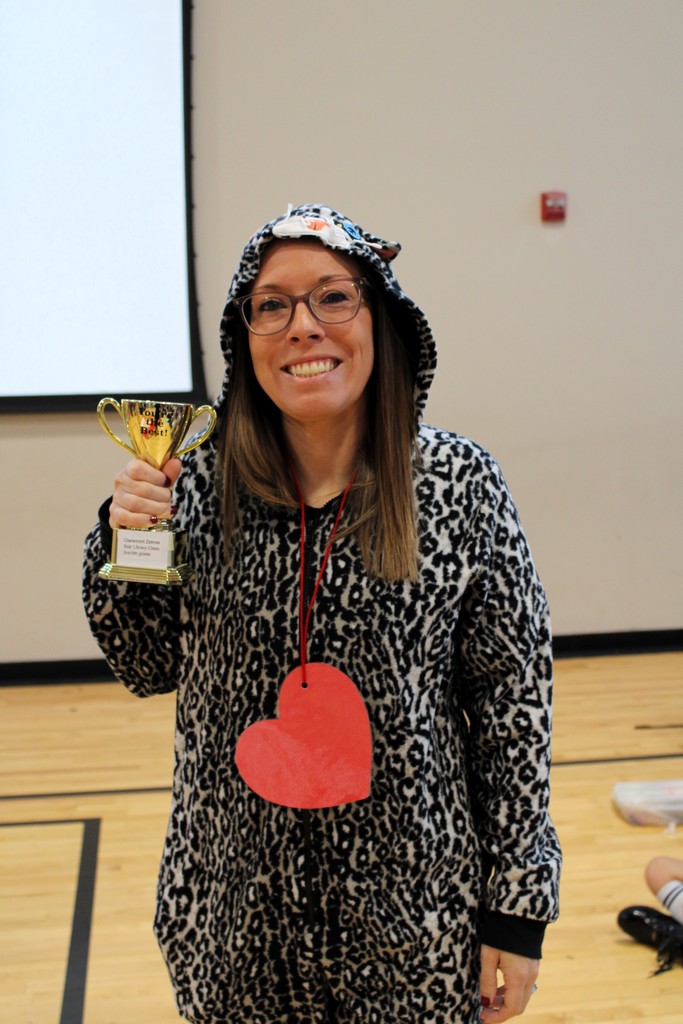 teacher holding trophy