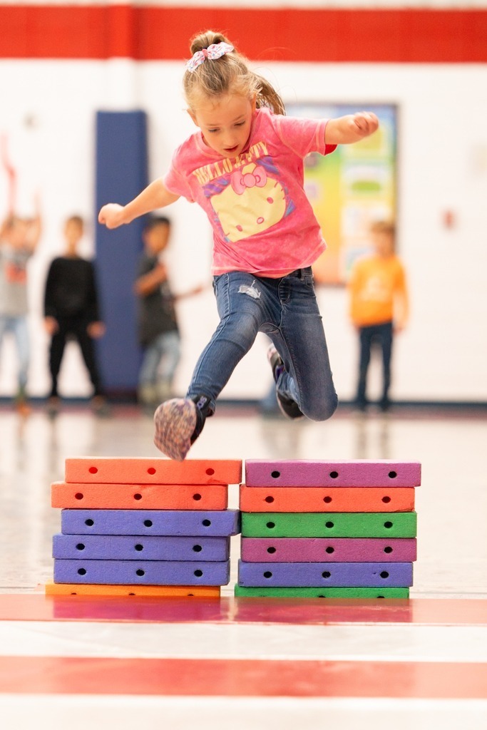 students practicing hurdles