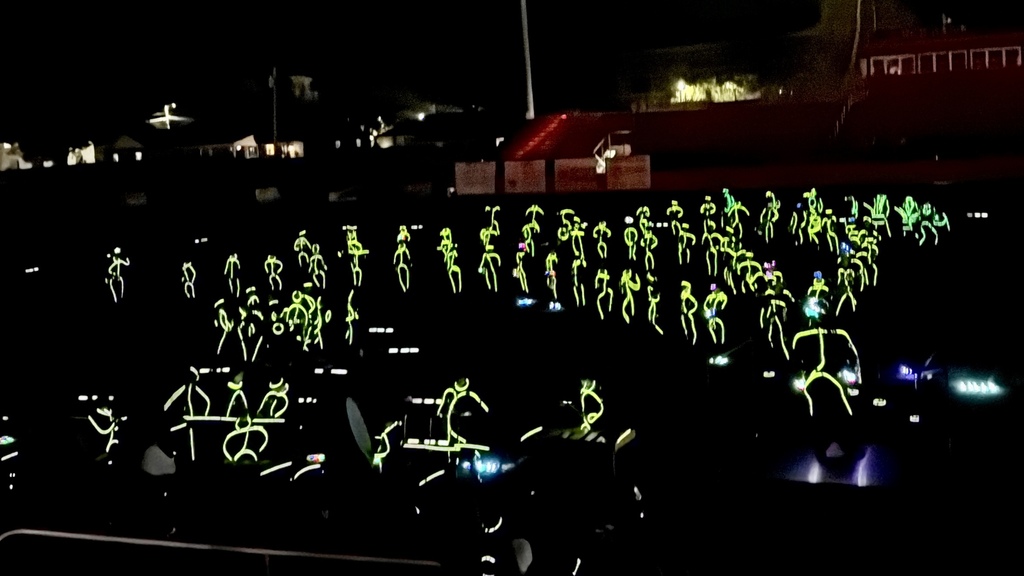 Students on the field in their glow sticks for the glow show