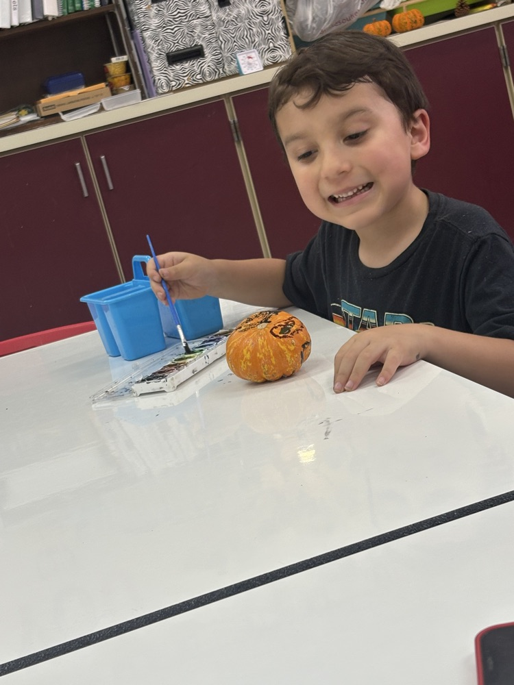 students painting pumpkins 