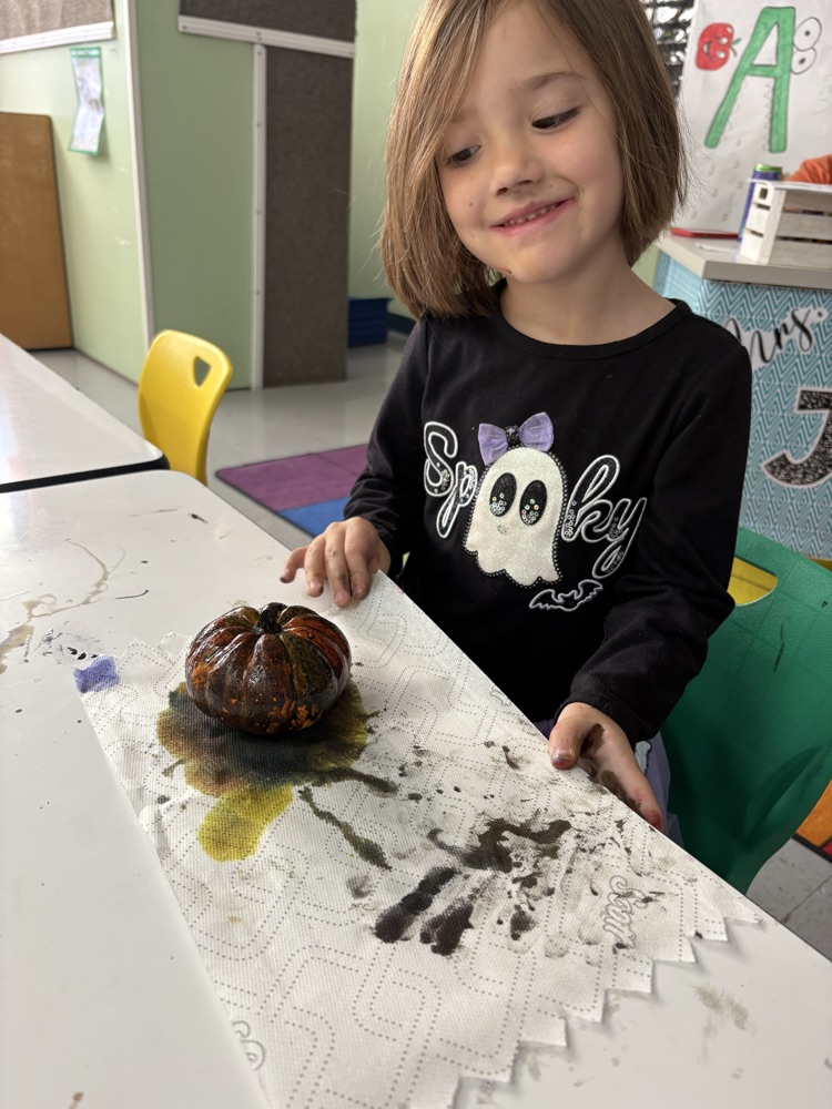 students painting pumpkins 