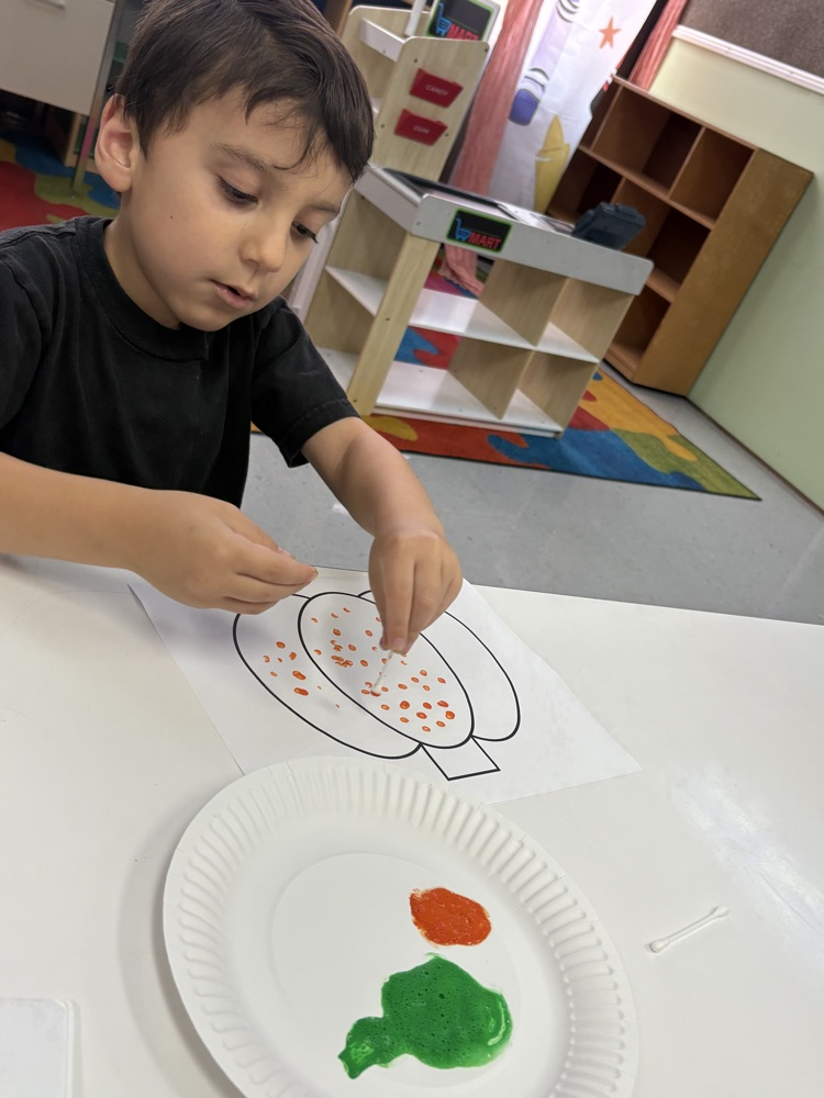students painting pumpkins 