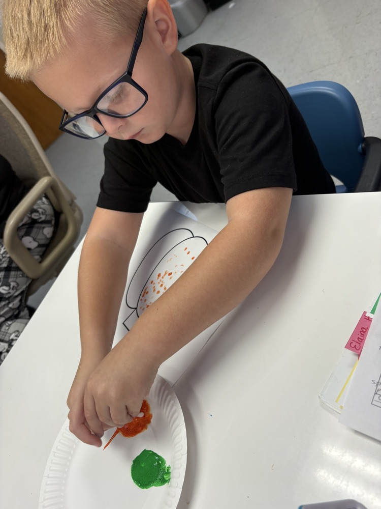 students painting pumpkins 