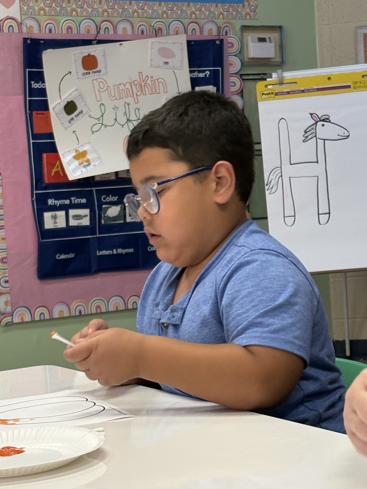 students painting pumpkins 