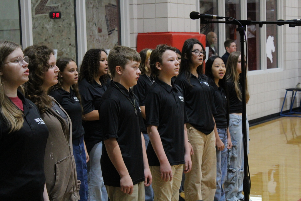 Advanced Choir singing at the GE assembly