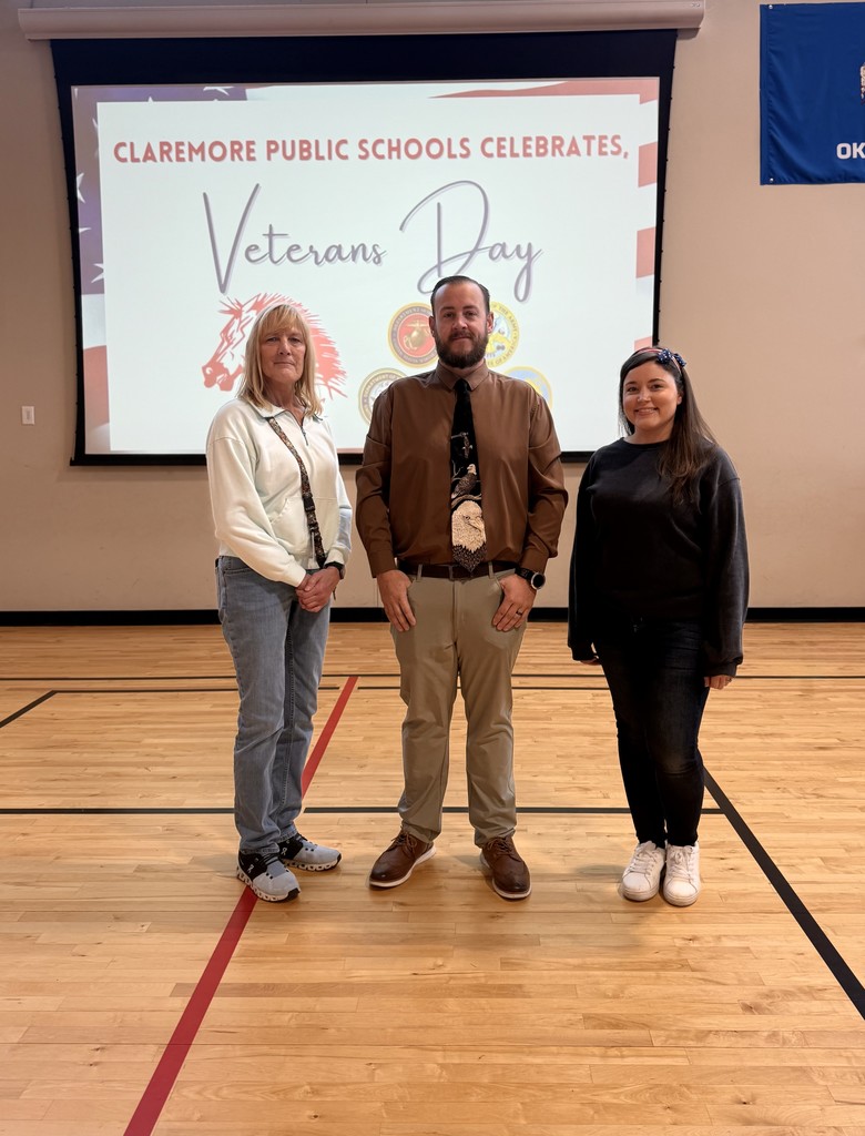 Three staff members standing for Veterans Day recognition 