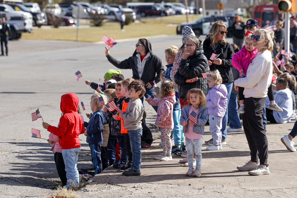 Elementary students celebrating Veteran's Day at parade.