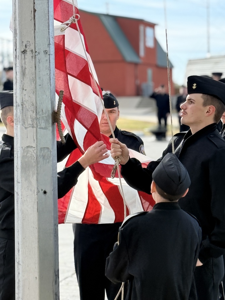 Claremore ROTC Students putting a new flag on the line a the American Legion after they retired it's last flag.
